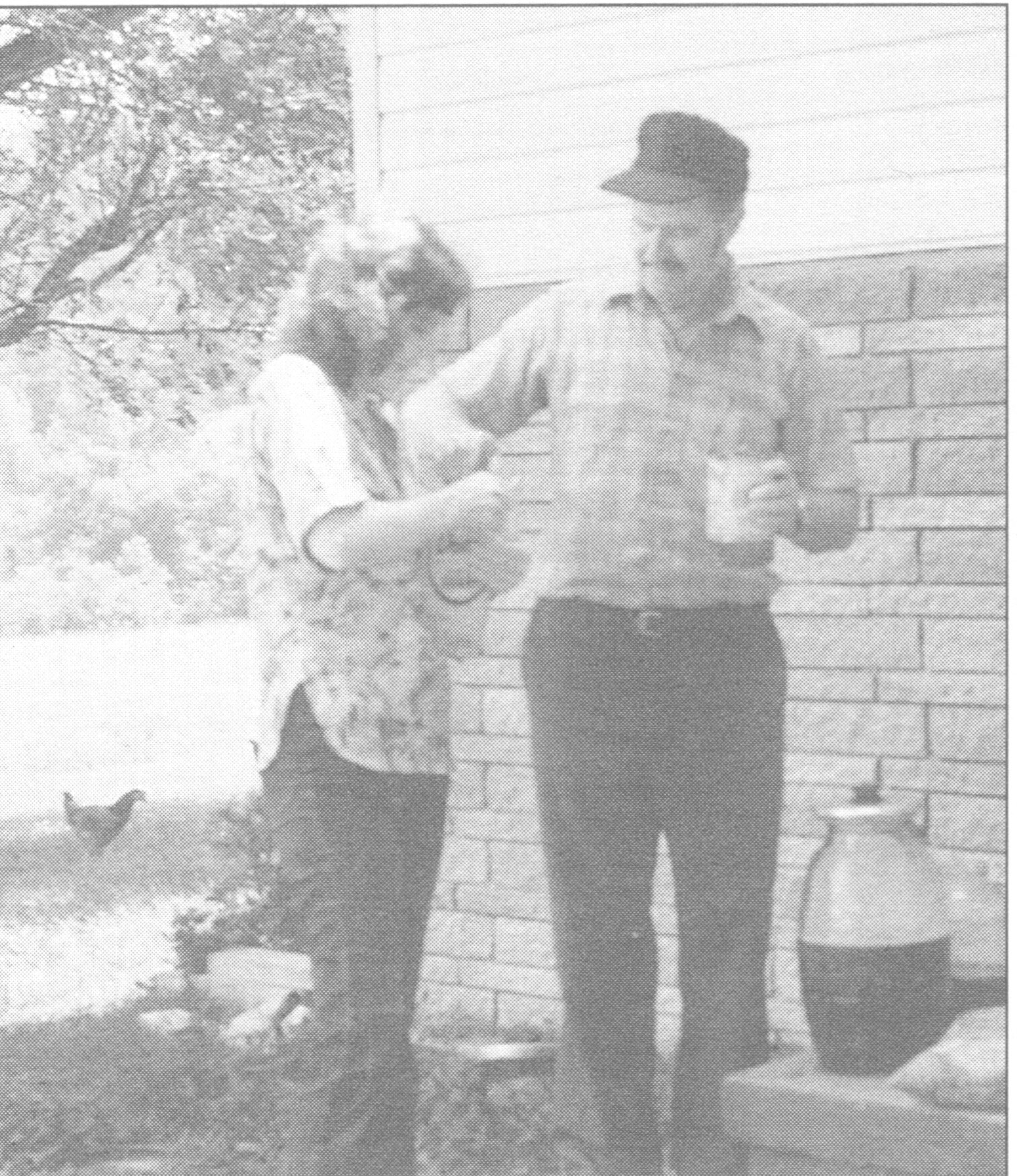 Vintage black-and-white family photograph of Parton relatives beside a moonshine jug in Sevierville, Tennessee